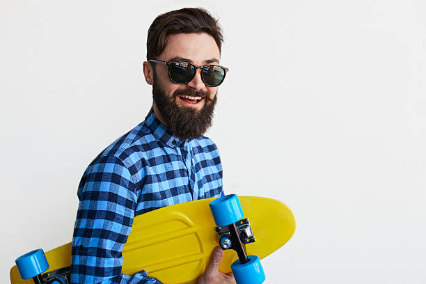 istock Handsome young man holding yellow skateboard 618049108