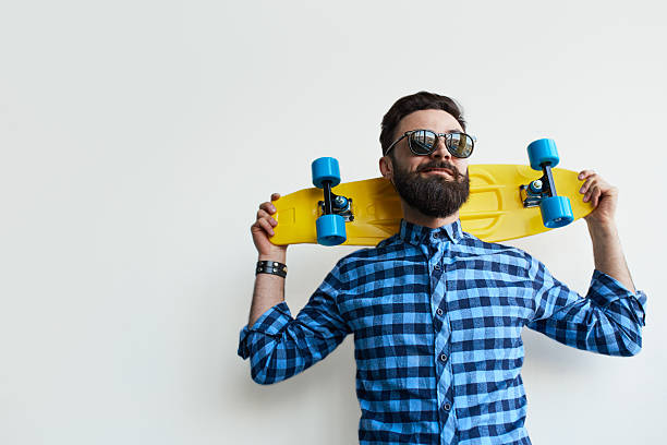istock skateboarder holding a skateboard behind his head. 618049148