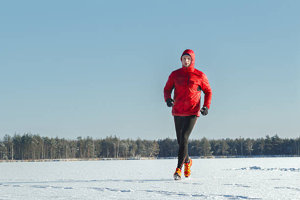 istock Running sportsman in red protective sportswear on winter training session 618049488