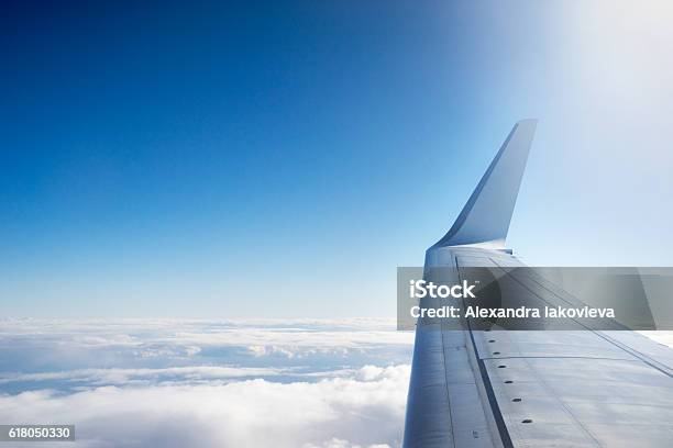 Airplane Wing Flying Above The Clouds Stock Photo - Download Image Now - Airplane, Aircraft Wing, Sky