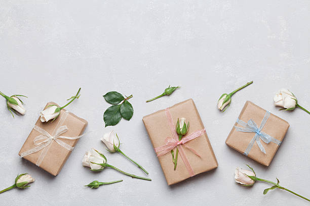 istock Present or gift decorated rose flowers. Holiday concept. Flat lay. 618051818