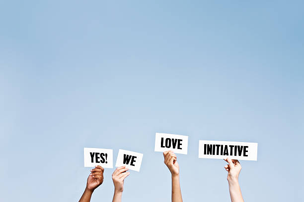 hand-held words say " yes! we love initiative" - impetus imagens e fotografias de stock
