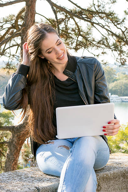 istock Beautiful girl sitting with a laptop 618053702