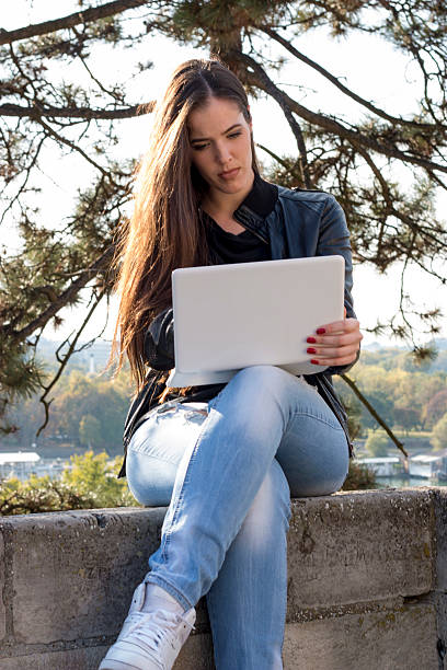 istock Beautiful girl sitting with a laptop 618054228