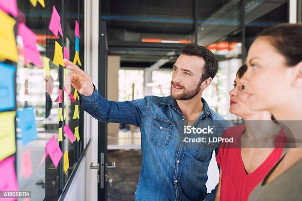 Three Businesspeople Discussing And Planning Concept Stock Photo - Download Image Now