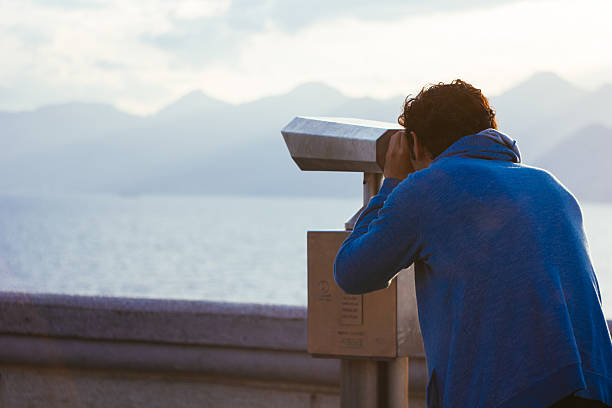 Young man looking through future stock photo