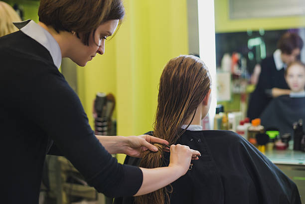 istock woman is making hair cut in salon 618059196