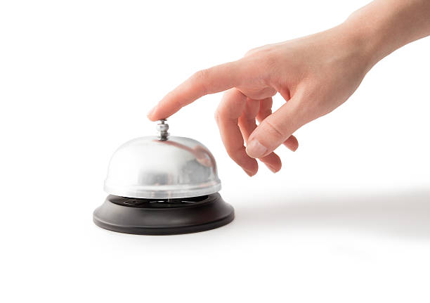 istock Woman hand pressing a hotel service bell 618059736