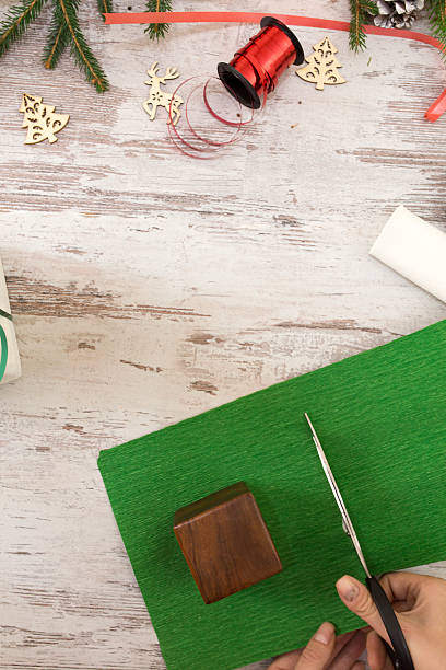 istock Hands of woman decorating Christmas gift box 618060512
