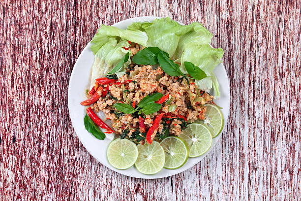 istock Fried spicy basil with minced pork topped sliced green lemon 618060540