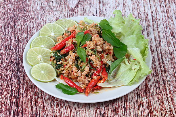 istock Fried spicy basil with minced pork topped sliced green lemon 618060758