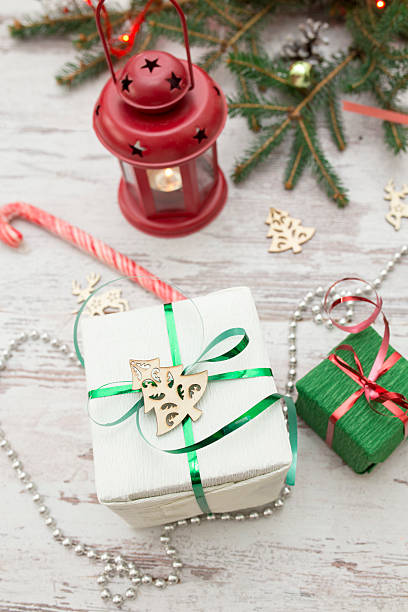 christmas presents wrapping and fir tree over wooden table background - new years eve christmas paper christmas fir tree imagens e fotografias de stock