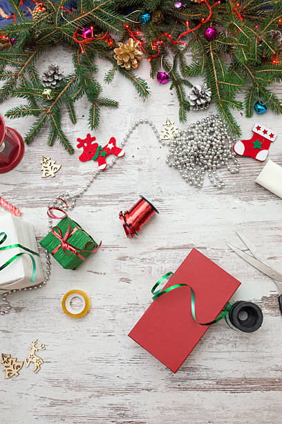 christmas presents wrapping and fir tree over wooden table background - new years eve christmas paper christmas fir tree imagens e fotografias de stock