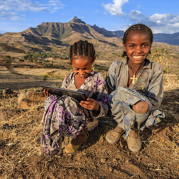 istock Little African girls using digital tablet, East Africa 618062116