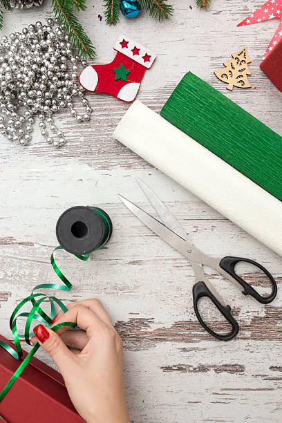 istock Hands of woman decorating Christmas gift box 618062126