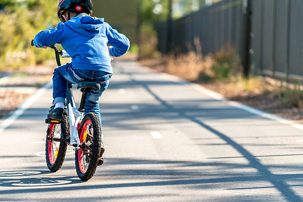 Australian boy riding his bicycle on bike lane on a day, South Australia