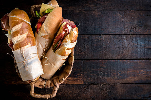 Sandwiches in the basket Served sandwiches in the basket on wooden background with blank space delicatessen stock pictures, royalty-free photos & images