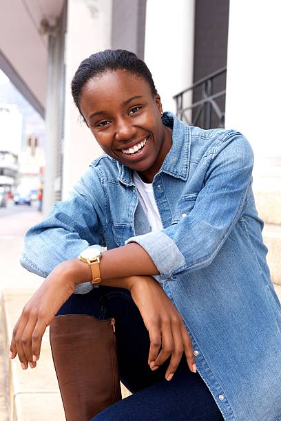 istock Young african woman smiling happily 618066896