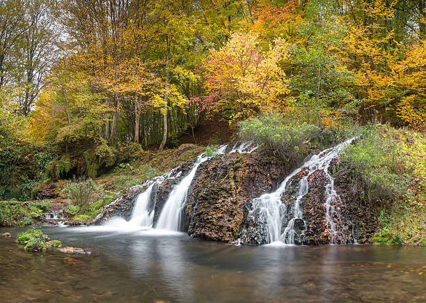 istock Waterfall in the forest in autumn 618068600