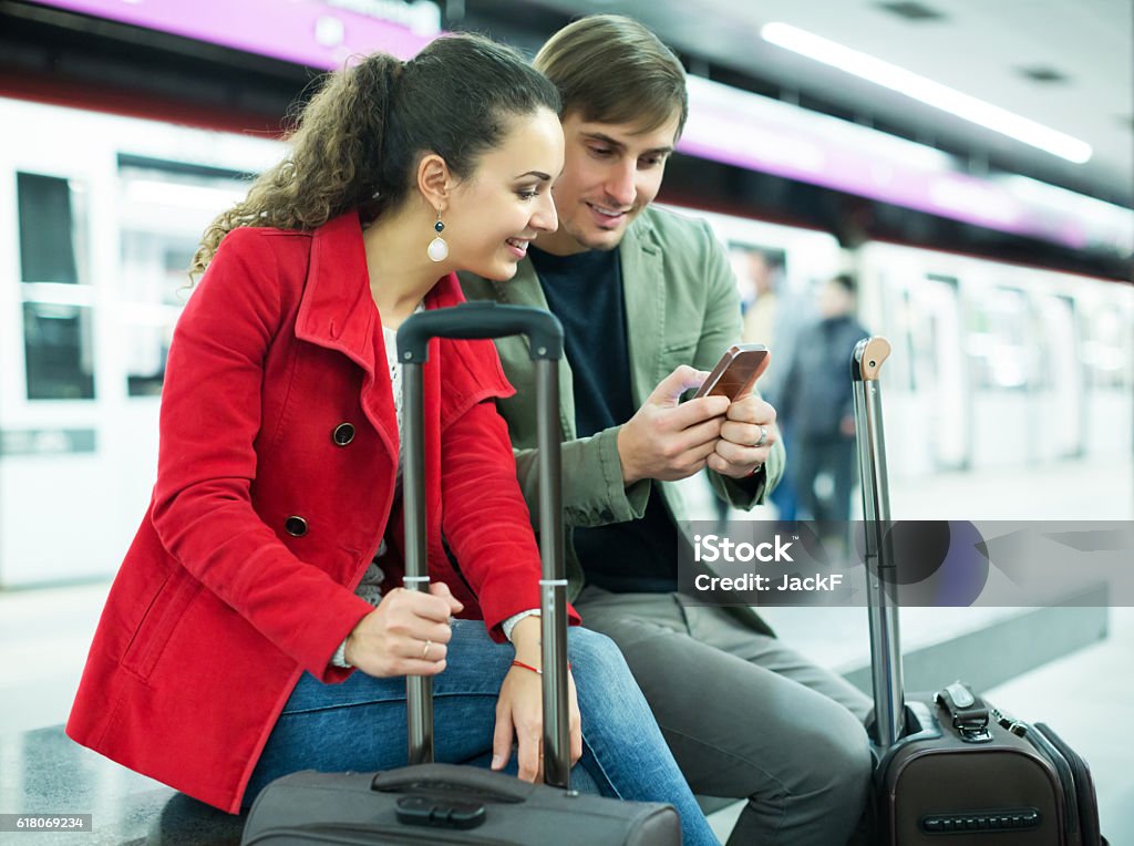 People reading news with phones People reading news with mobile phones underground Map Stock Photo