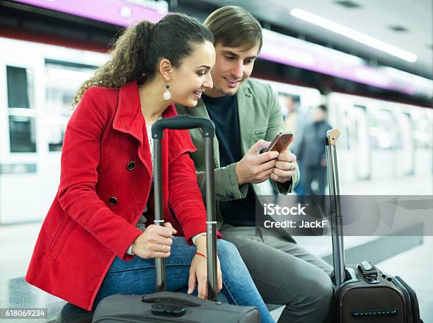 People Reading News With Phones Stock Photo - Download Image Now - Map, Reading, Couple - Relationship