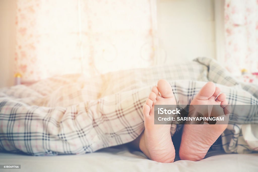 Nahaufnahme der Füße von Frauen, die am Morgen auf dem Bett schlafen - Lizenzfrei Unterhalb Stock-Foto