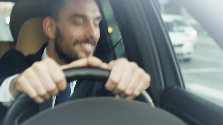 Happy Smiling Businessman Driving a Car