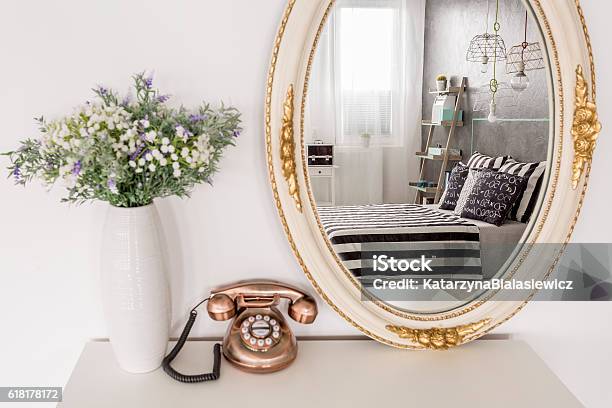 Classic Mirror Standing Next To Vintage Telephone And White Vase Stock Photo - Download Image Now