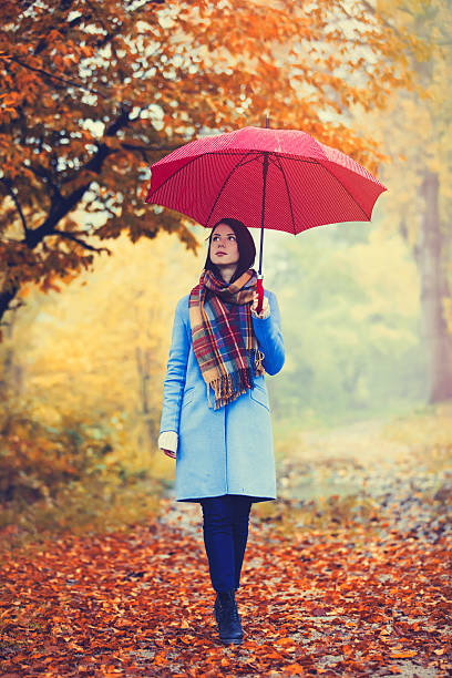 istock brunette girl with umbrella 618179774