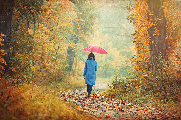 istock brunette girl with umbrella 618180404