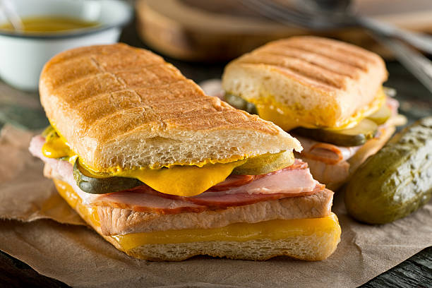 Cuban Cubano Sandwich An authentic cuban sandwich on pressed medianoche bread with pork, ham, cheese, pickle, and mustard. cuban culture photos stock pictures, royalty-free photos & images