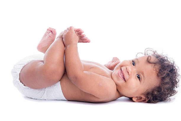 istock Biracial Baby Lying on her Back Holding Feet Isolated 618187404