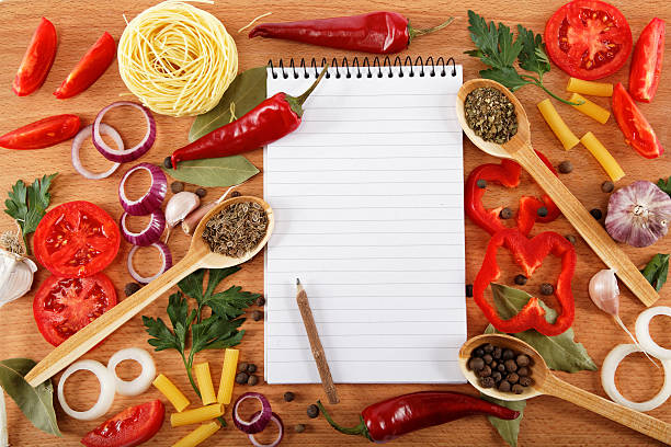 istock notebook for recipes, vegetables and spices on wooden table. 618187986