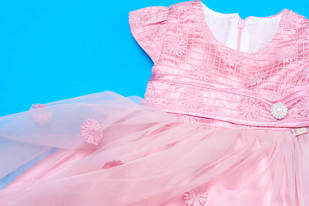 istock Clothes for baby girl on a pink background. Copy space 618188892