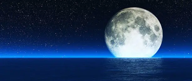 Photo of Rising moon over sea.