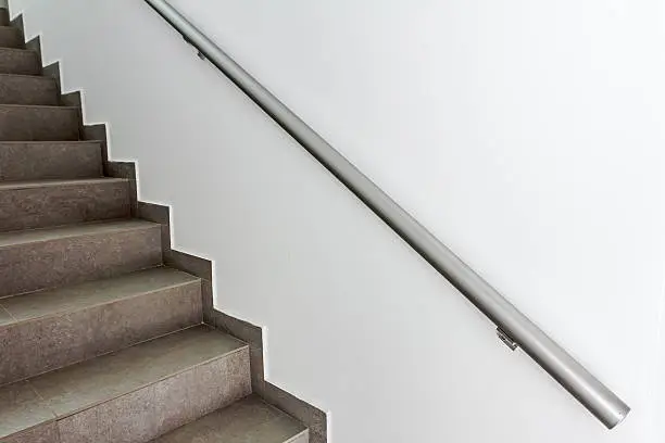 Stairway with metallic banister in a new modern building. Every building is required to have emergency stairways as safety measure.