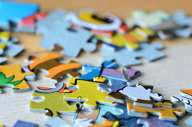 istock Children's puzzles on a wooden background close up 618192666