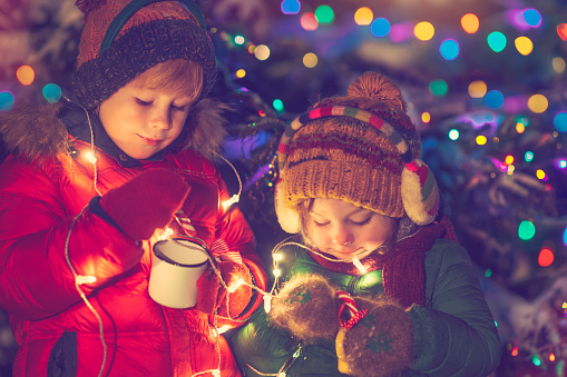 Little girl and boy in Christmas outdoors