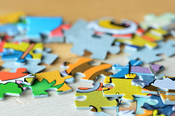 istock Children's puzzles on a wooden background close up 618192734