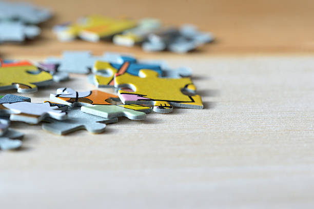 istock Children's puzzles on a wooden background close up 618192956