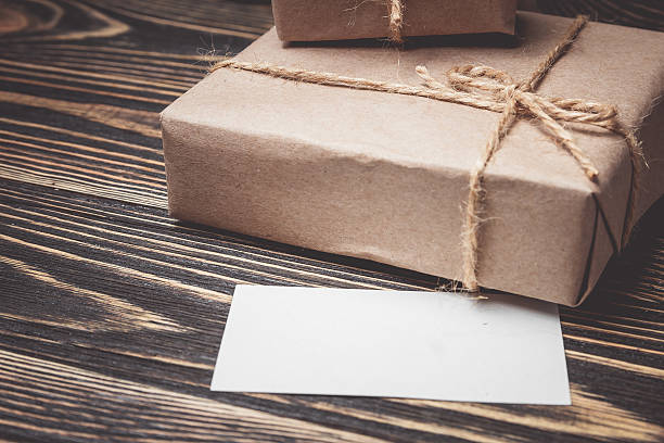 istock Vintage gift box with blank tag on old wooden background. 618193170