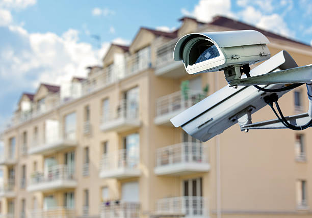 CCTV camera with modern luxury residence security CCTV camera or surveillance system with modern luxury residence on blurry background cityscape videos stock pictures, royalty-free photos & images