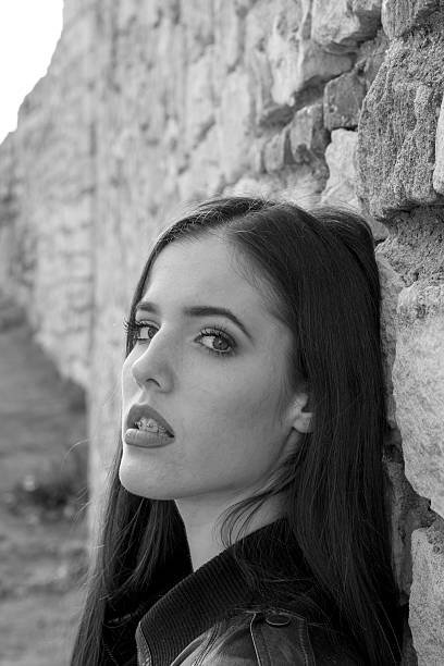 istock Beautiful girl leaned the wall and posing 618194052