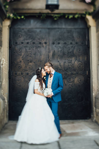 istock bride standing in background church door 618195496