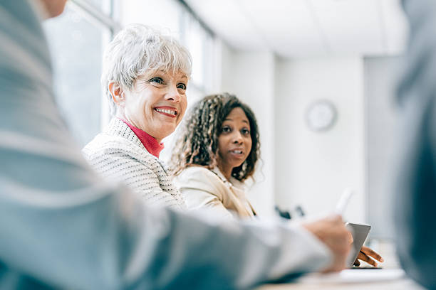 Business Team Meeting Multiracial Business Team of women meeting in board room hireage stock pictures, royalty-free photos & images