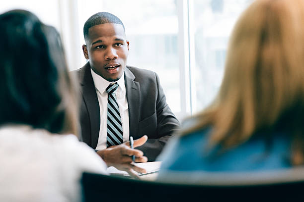 Financial Advisor Two women at a meeting with a financial advisor african american business couple stock pictures, royalty-free photos & images