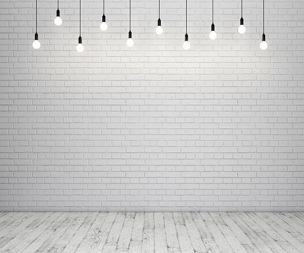 Painted brick wall and wooden floor with glowing light bulbs