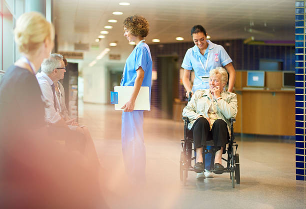 elderly patient leaves hospital - huisarts druk stockfoto's en -beelden