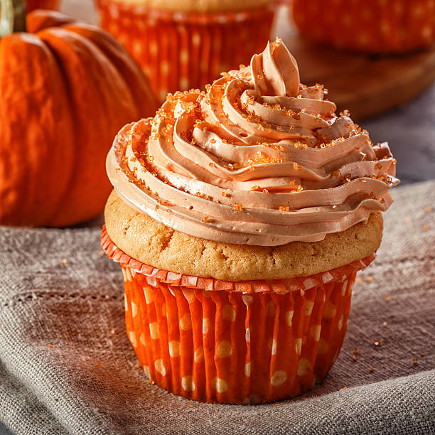 istock Pumpkin cupcakes with glitter sugar sprinkles. 618201154