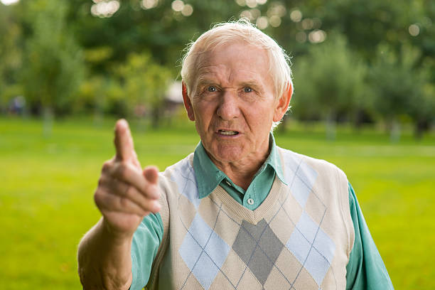 Senior man threatens with finger.